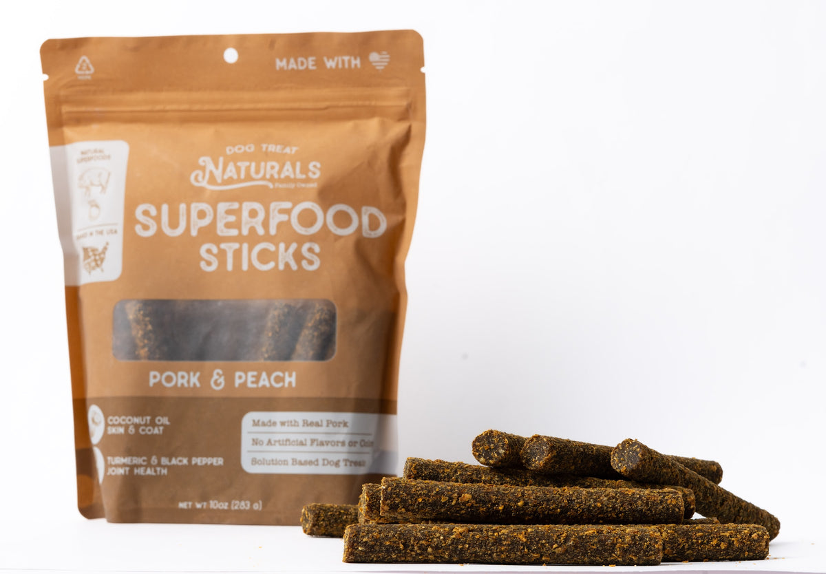 Pork & Peach Superfood Sticks bag with the treats out in front of it